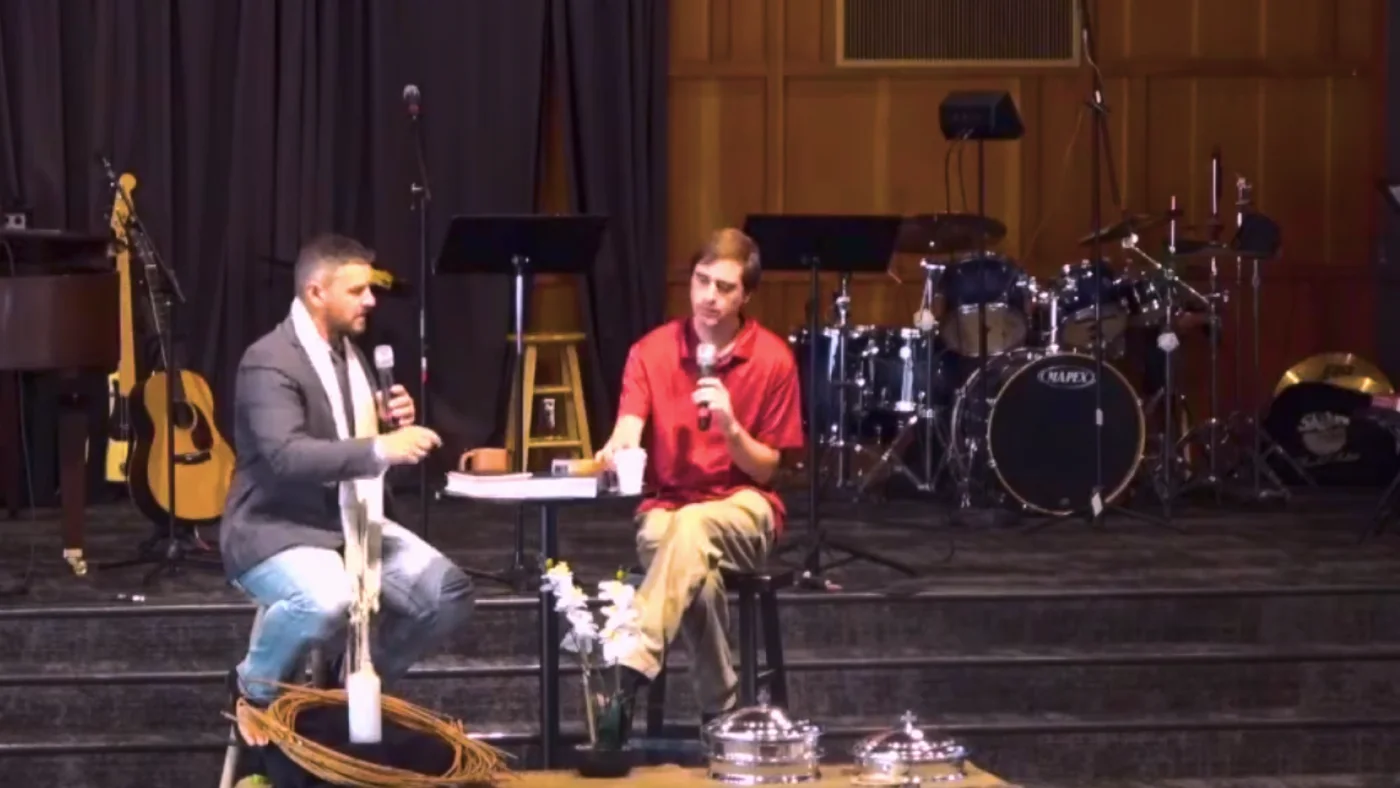 Pastor Josh and Pastor David in conversation on stage during a Sunday sermon